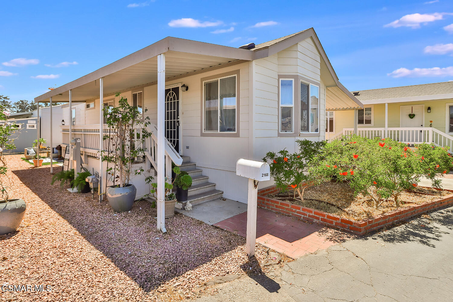 2168 Thrush Avenue, Unit 2168J Oxnard, CA 93033 - Photo 3 of 37 a front view of a house with garden
