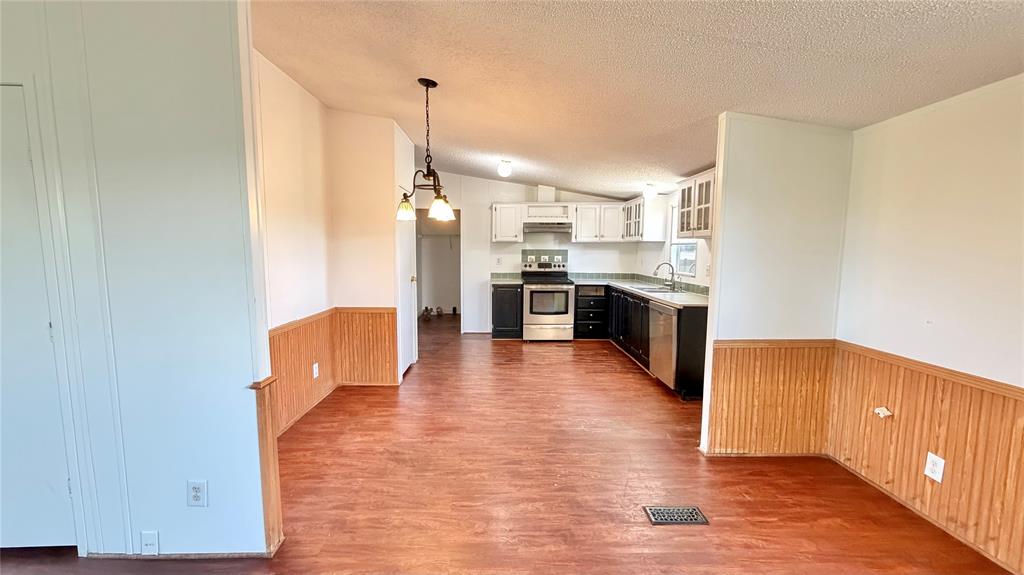 3789 Jacobs Lane Kaufman, TX 75142 - Photo 8 of 33 a large kitchen with cabinets wooden floor and stainless steel appliances