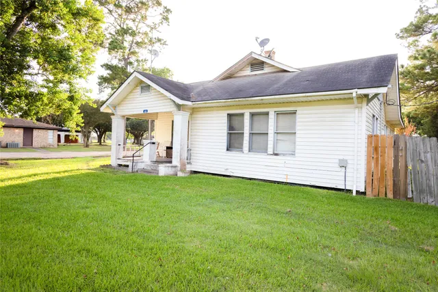 a view of a house with a yard patio and fire pit
