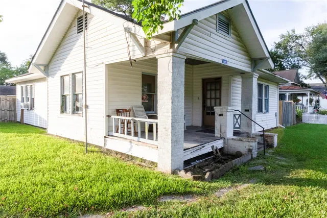 a view of house with backyard outdoor seating and hardwood