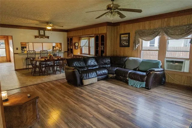 a living room with furniture a fireplace and a window