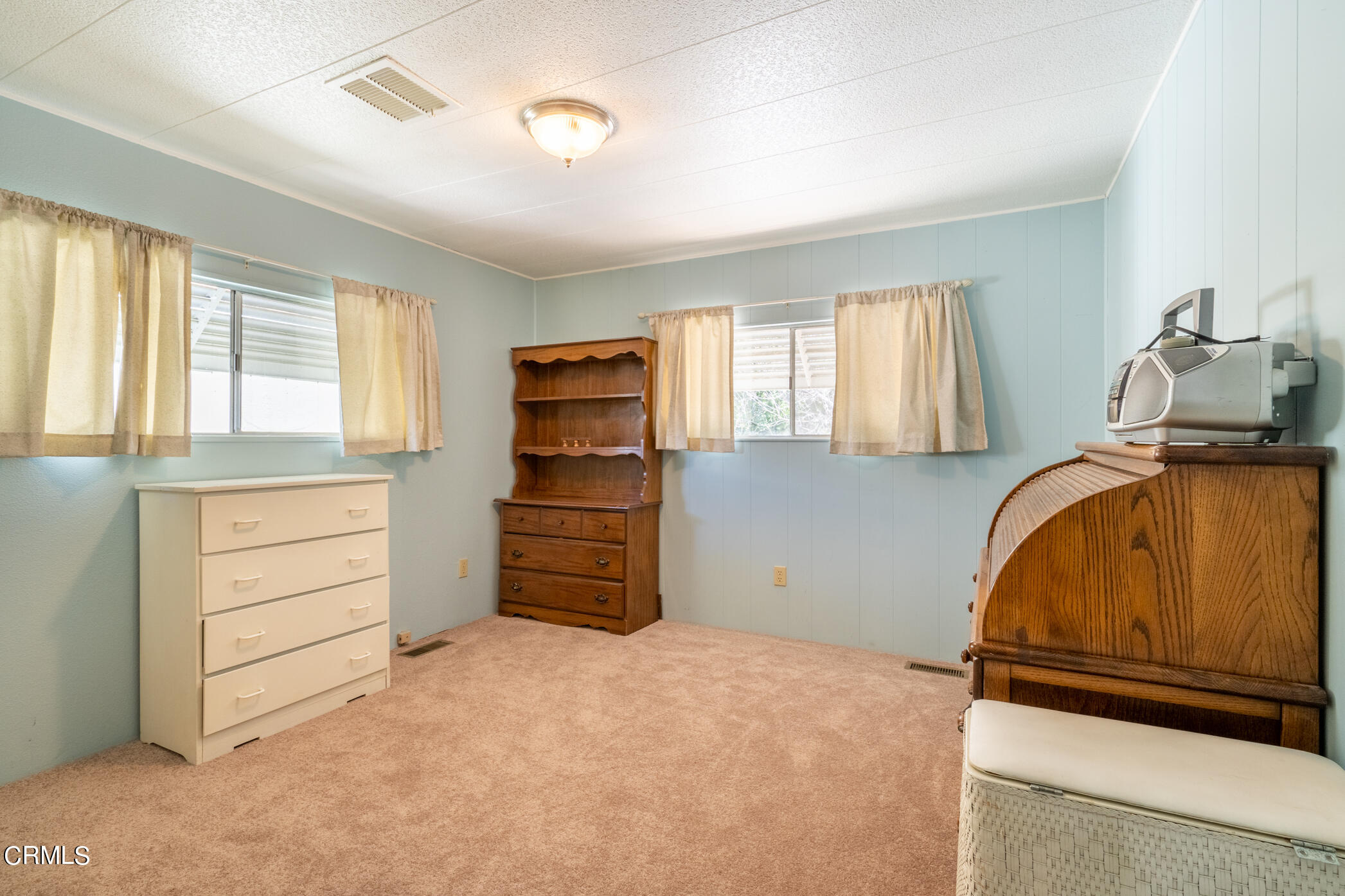 1225 South Rice Road, Unit 63 Ojai, CA 93023 - Photo 11 of 23 a bedroom with a bed and cabinets