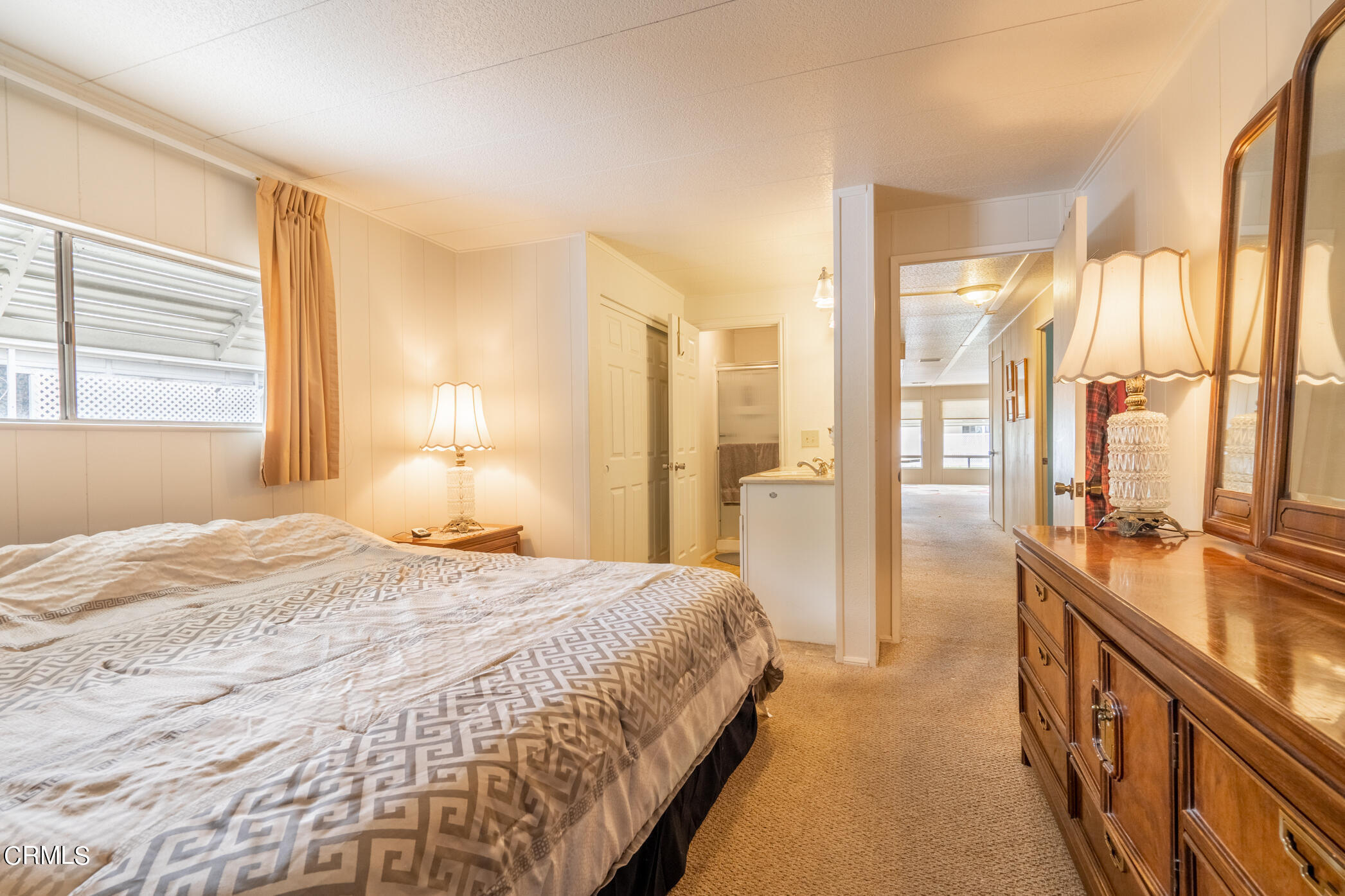 1225 South Rice Road, Unit 63 Ojai, CA 93023 - Photo 13 of 23 a spacious bedroom with a bed and a large window
