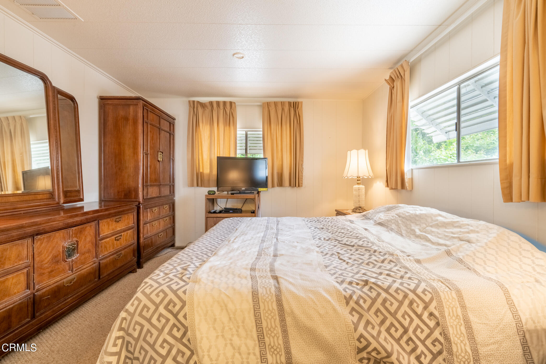 1225 South Rice Road, Unit 63 Ojai, CA 93023 - Photo 14 of 23 a bedroom with a bed and a large window