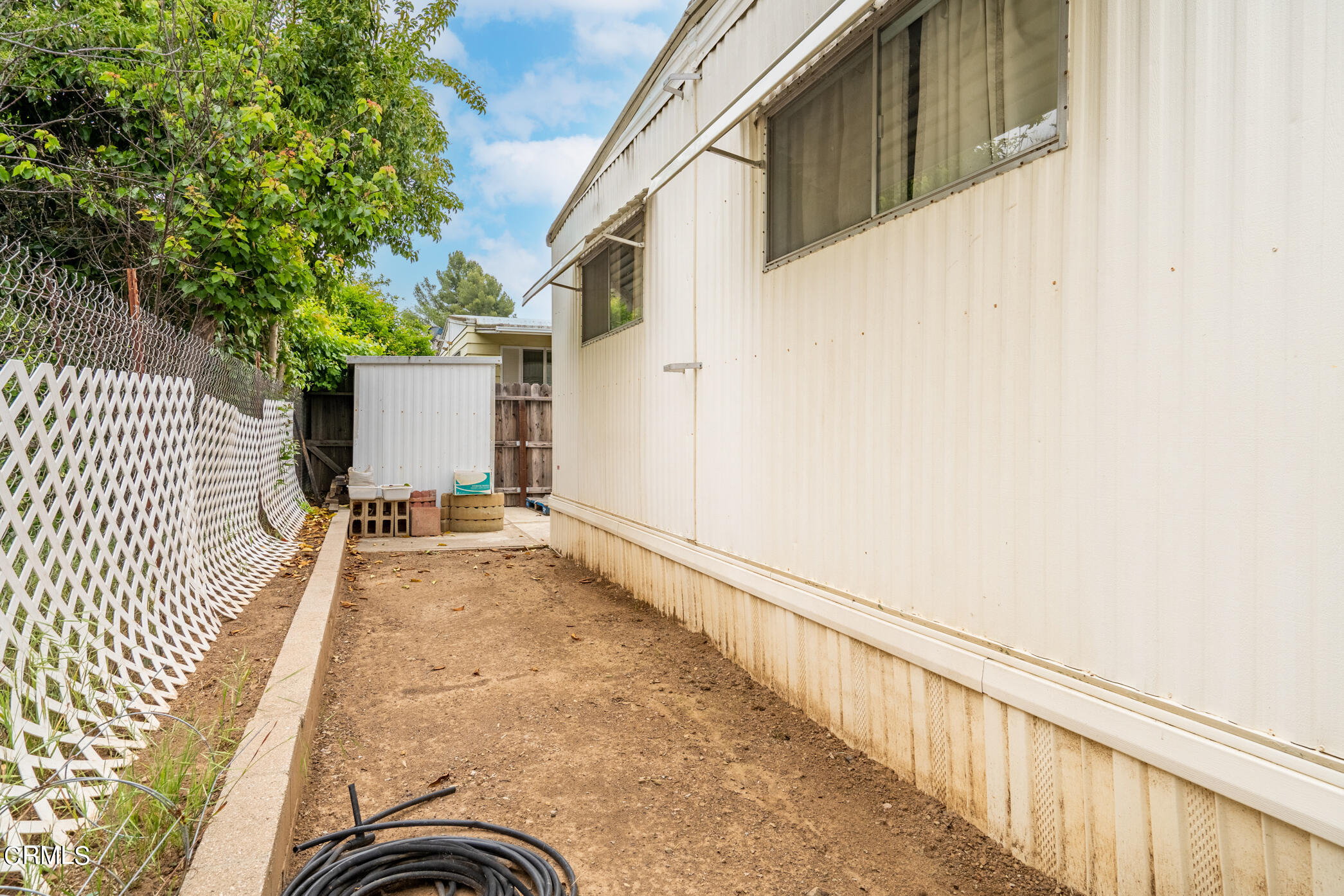 1225 South Rice Road, Unit 63 Ojai, CA 93023 - Photo 19 of 23 a view of a house with a backyard