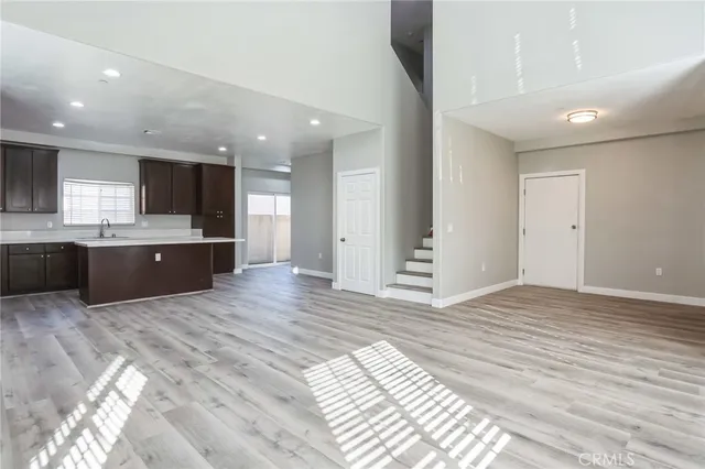 a view of kitchen and hall with wooden floor