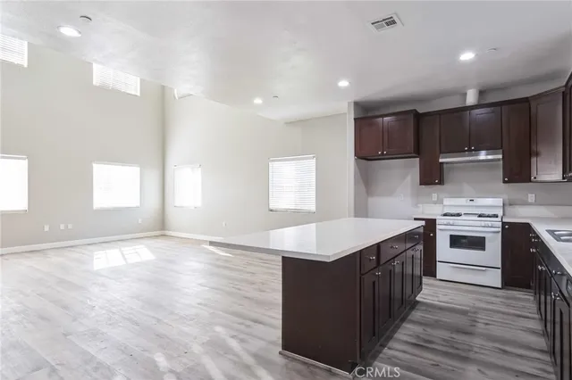 a kitchen with a stove a sink and a refrigerator