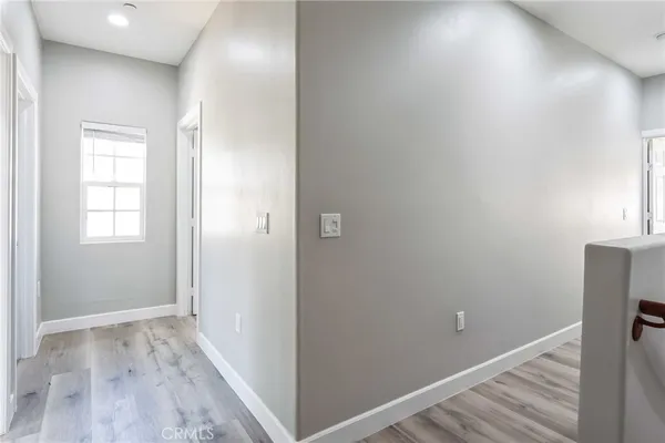 a view of a hallway with wooden floor