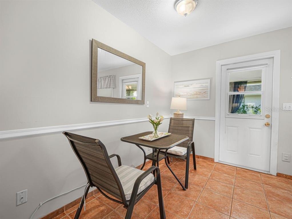 549 Sutton Place, Unit T 19 Longboat Key, FL 34228 - Photo 11 of 52 a view of a dining room with furniture and a window