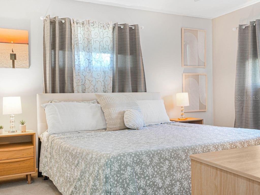 549 Sutton Place, Unit T 19 Longboat Key, FL 34228 - Photo 14 of 52 a bedroom with a large bed and a large window