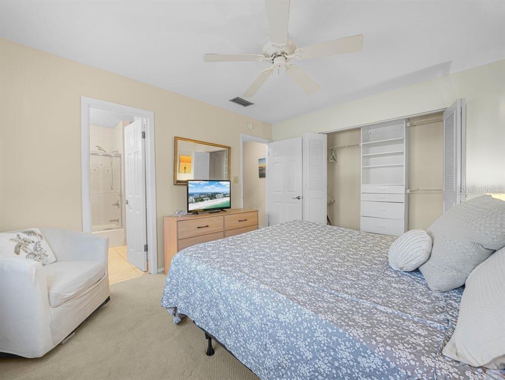 549 Sutton Place, Unit T 19 Longboat Key, FL 34228 - Photo 15 of 52 a spacious bedroom with a bed and a couch