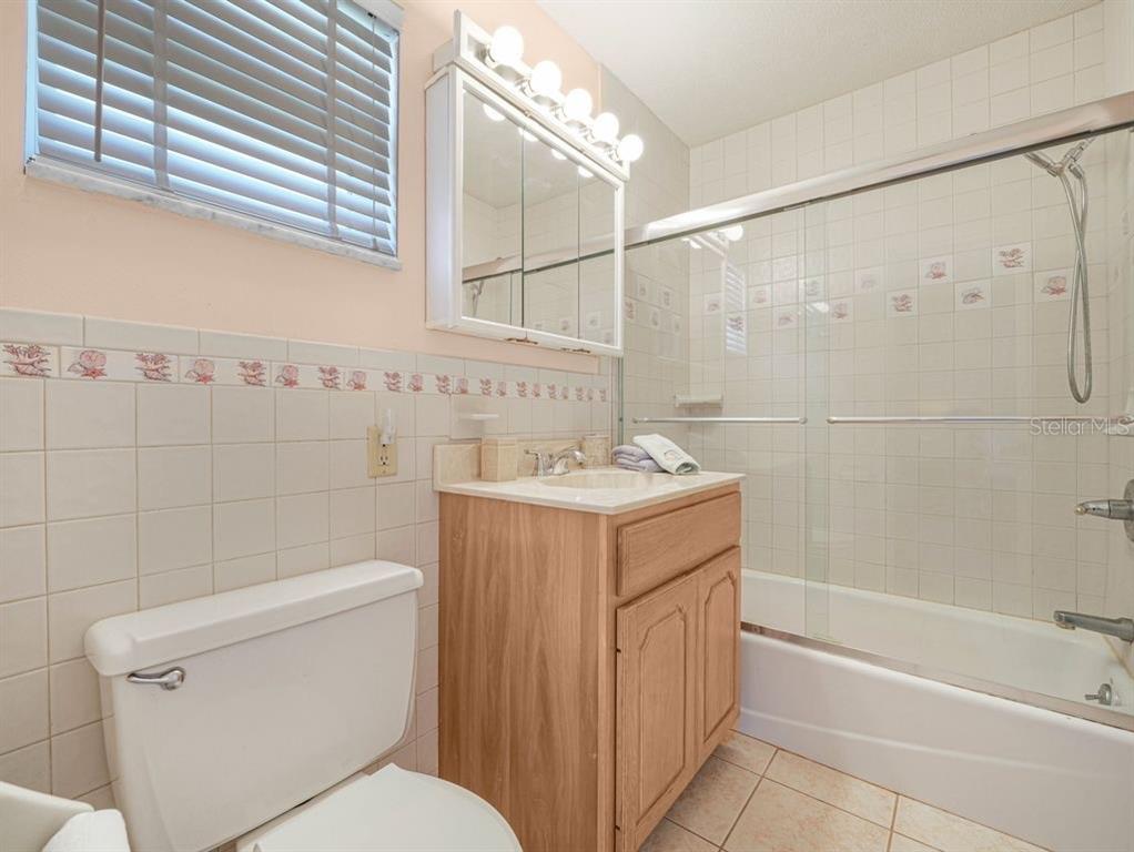 549 Sutton Place, Unit T 19 Longboat Key, FL 34228 - Photo 19 of 52 a bathroom with a sink a toilet and shower