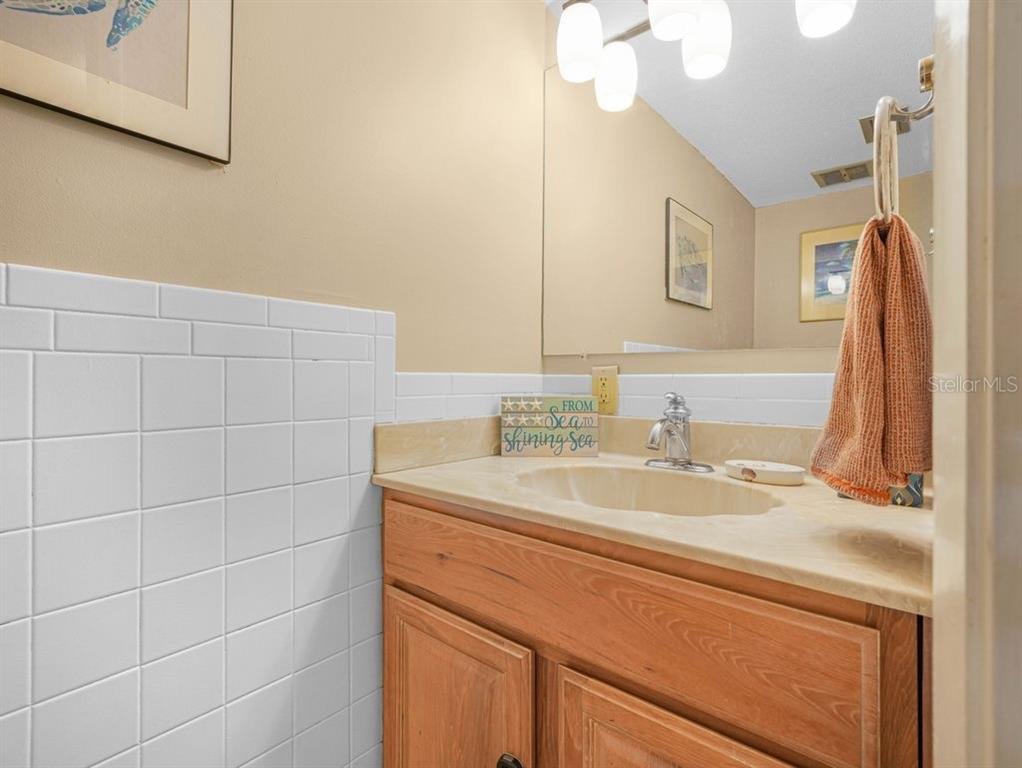 549 Sutton Place, Unit T 19 Longboat Key, FL 34228 - Photo 23 of 52 a bathroom with a sink and a mirror