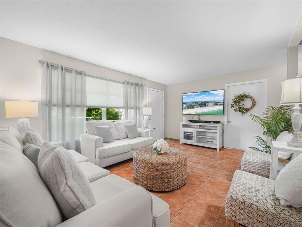 549 Sutton Place, Unit T 19 Longboat Key, FL 34228 - Photo 3 of 52 a living room with furniture and a large window