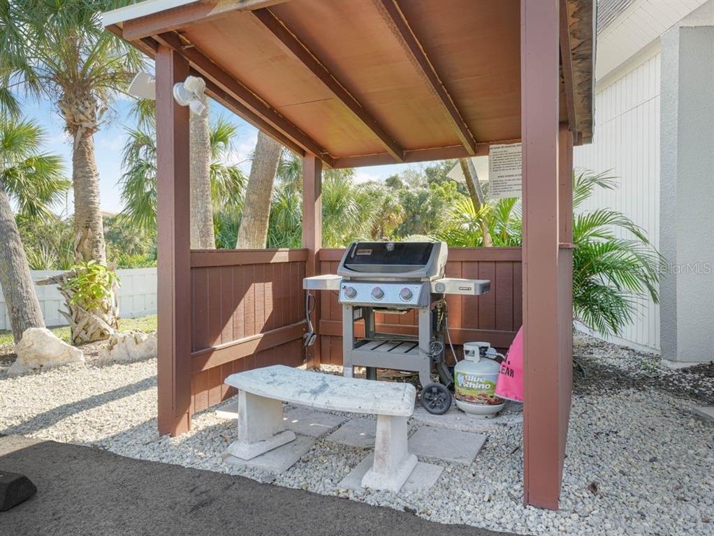 549 Sutton Place, Unit T 19 Longboat Key, FL 34228 - Photo 34 of 52 a outdoor space with the couches and dining table with the garden view