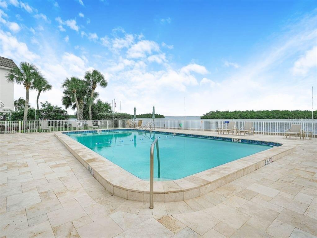 549 Sutton Place, Unit T 19 Longboat Key, FL 34228 - Photo 40 of 52 a view of a swimming pool with a yard