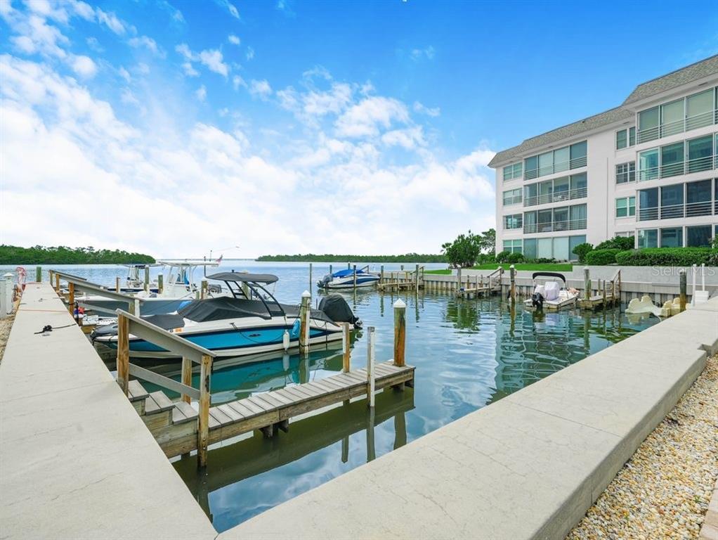 549 Sutton Place, Unit T 19 Longboat Key, FL 34228 - Photo 43 of 52 a view of a lake with a terrace