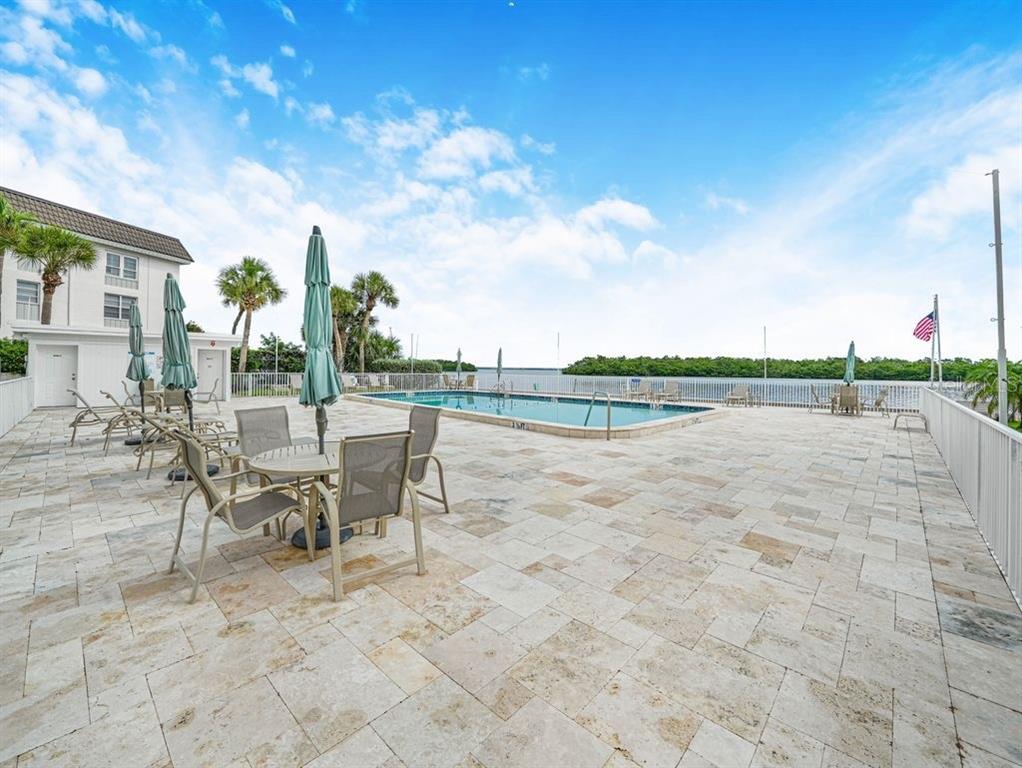 549 Sutton Place, Unit T 19 Longboat Key, FL 34228 - Photo 44 of 52 a view of a lake with outdoor space