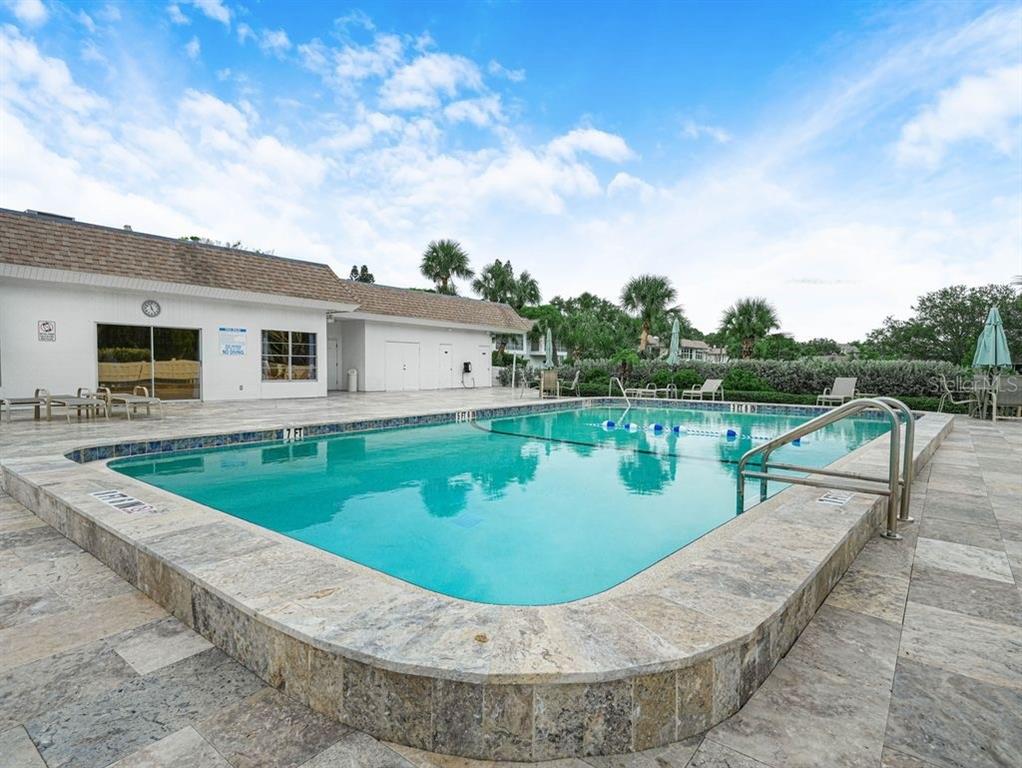 549 Sutton Place, Unit T 19 Longboat Key, FL 34228 - Photo 47 of 52 a view of a swimming pool with a patio