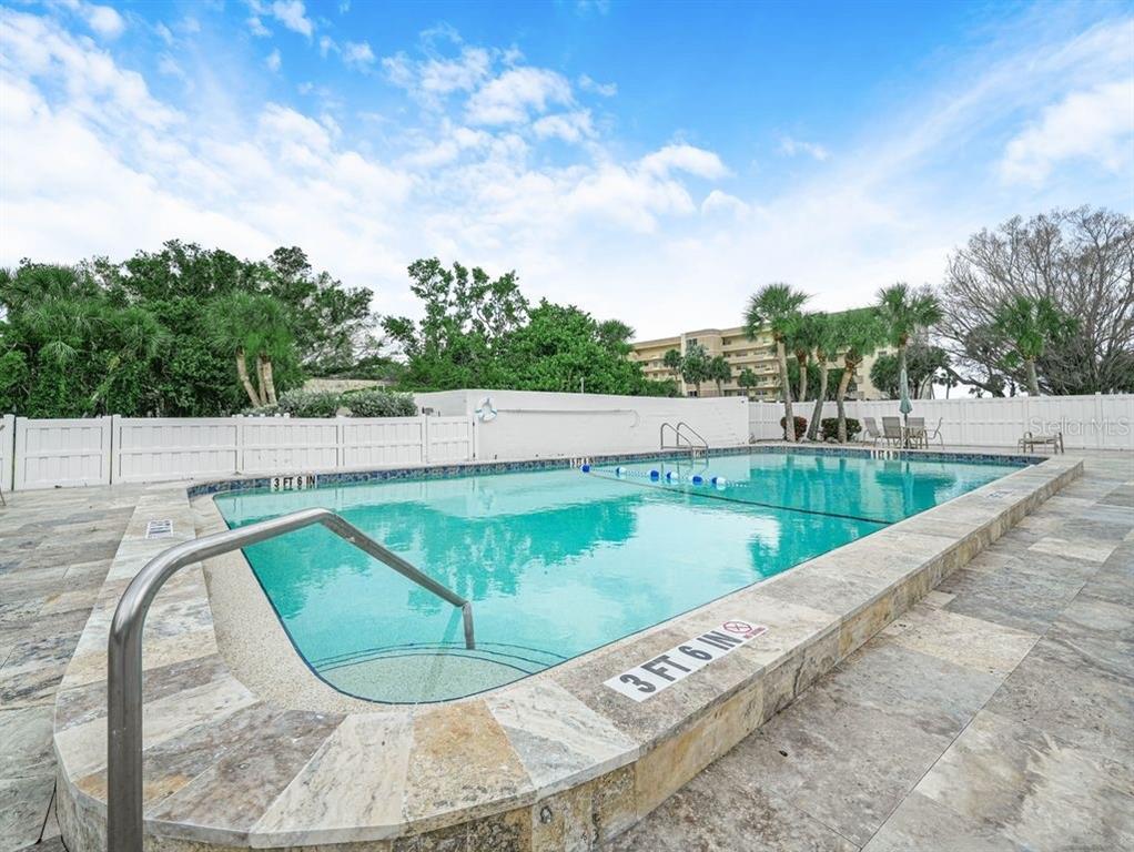549 Sutton Place, Unit T 19 Longboat Key, FL 34228 - Photo 49 of 52 a view of a swimming pool with a yard