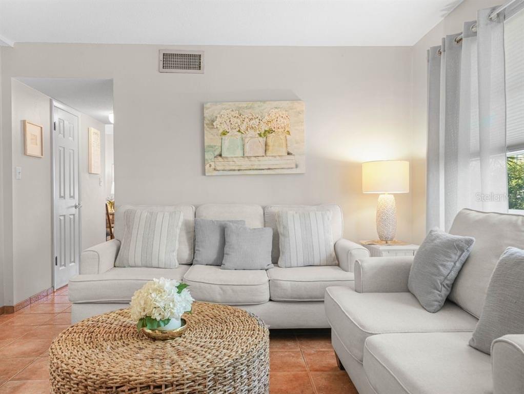 549 Sutton Place, Unit T 19 Longboat Key, FL 34228 - Photo 5 of 52 a living room with furniture and a couch