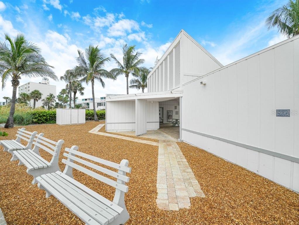 549 Sutton Place, Unit T 19 Longboat Key, FL 34228 - Photo 52 of 52 a view of a white building with a yard and plants