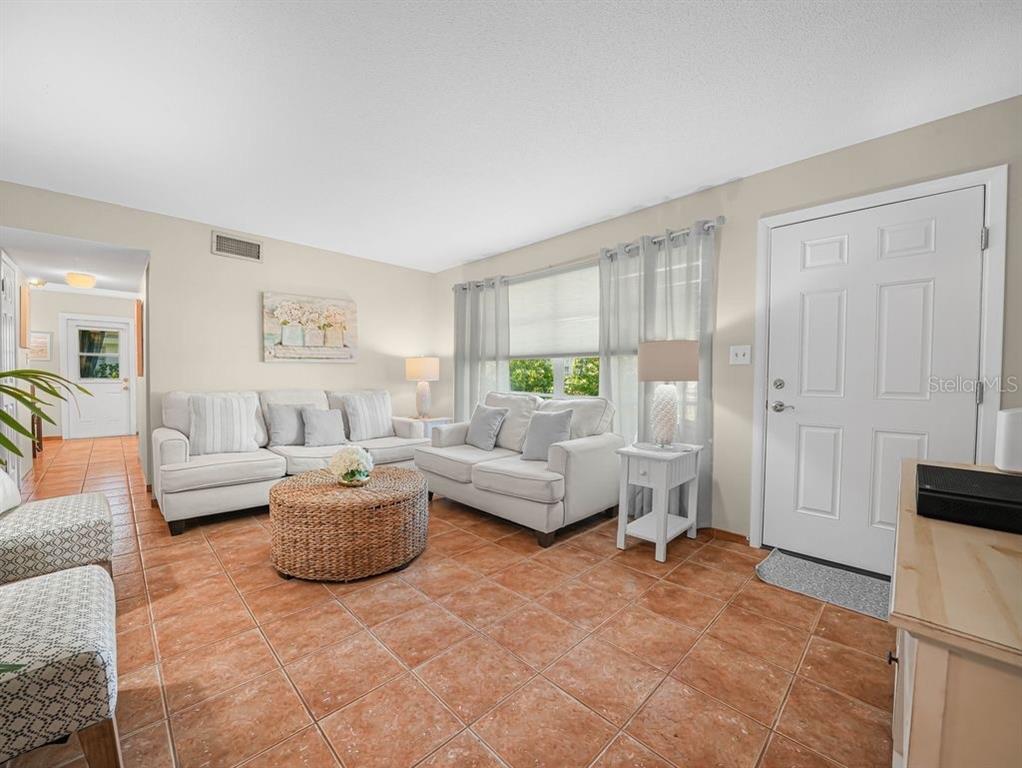 549 Sutton Place, Unit T 19 Longboat Key, FL 34228 - Photo 6 of 52 a living room with furniture and a window