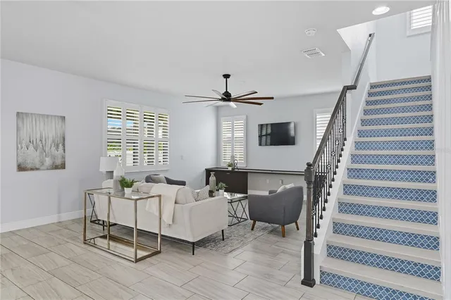 a living room with furniture and a chandelier