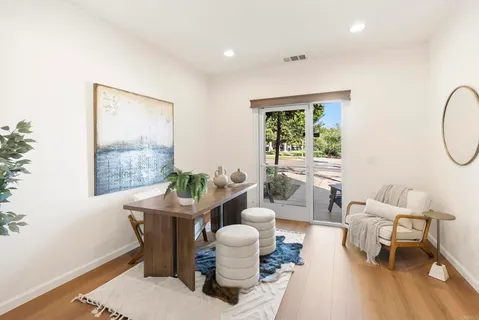a living room with furniture a table and a large window