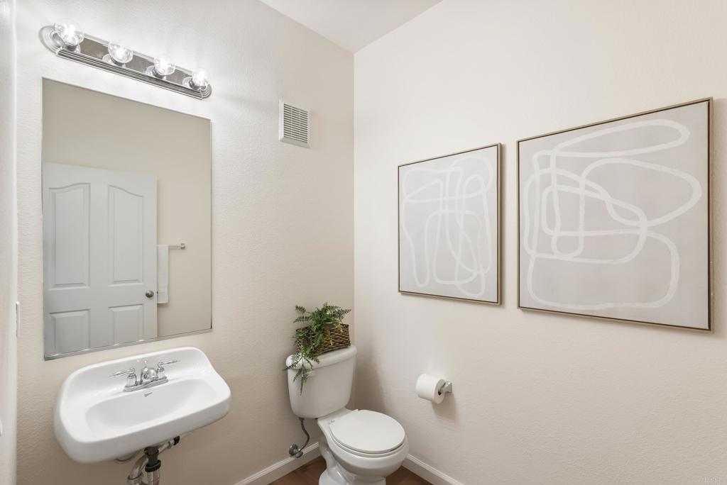 1276 San Elijo Road North San Marcos, CA 92078 - Photo 18 of 35 a bathroom with a toilet a sink and mirror