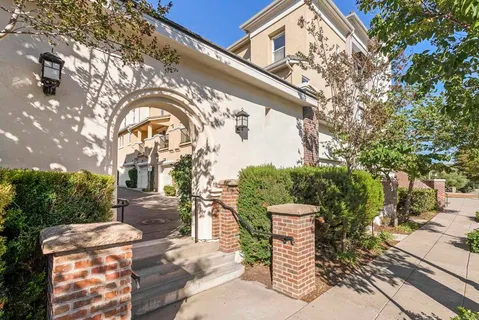 a front view of a house with a garden