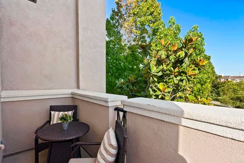 a bedroom with a bed and a potted plant