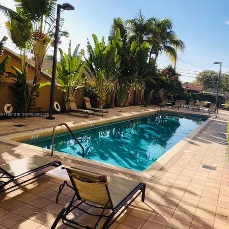 a view of a backyard with sitting area