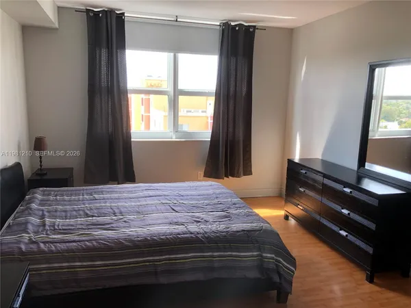 a bedroom with a bed and a window