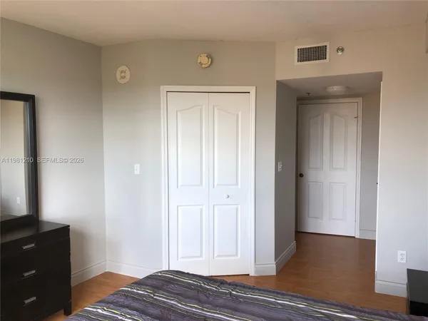 a view of bedroom with wooden floor