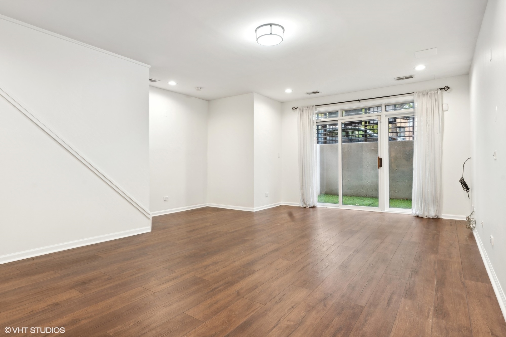 1372 North Dean Street, Unit 1 Chicago, IL 60622 - Photo 12 of 26 wooden floor in an empty room with a window