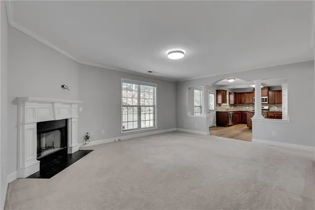 a view of empty room with a fireplace