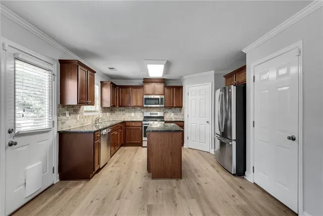 a kitchen with stainless steel appliances granite countertop a sink stove microwave and cabinets