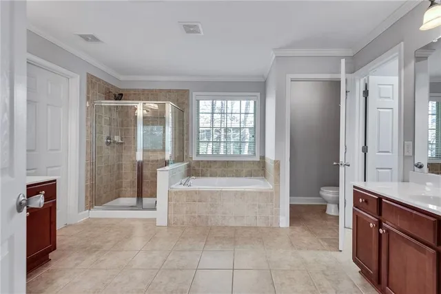 a spacious bathroom with a bathtub sink and mirror