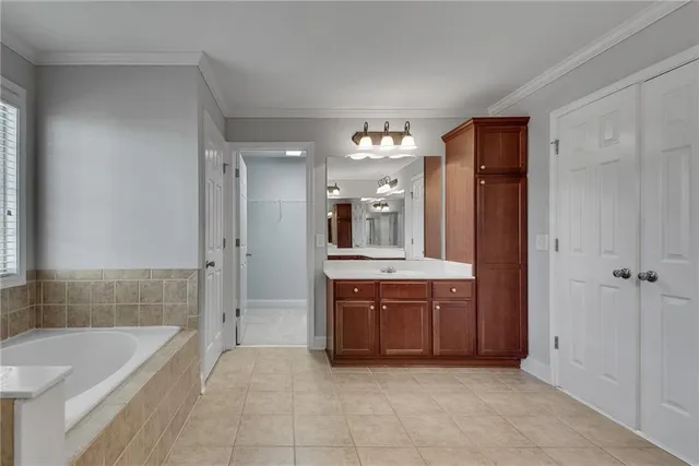a spacious bathroom with a granite countertop sink a mirror and a vanity