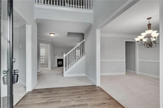a view of entryway and hall with wooden floor