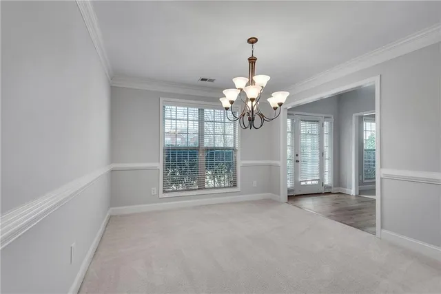 a view of a chandelier fan and wooden floor
