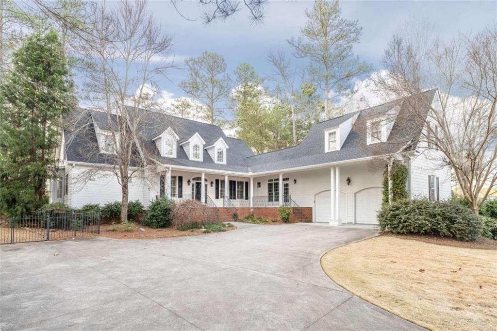 33 Nicklaus Drive Northwest Rome, GA 30165 - Photo 1 of 1 a view of a white house with a yard and potted plants