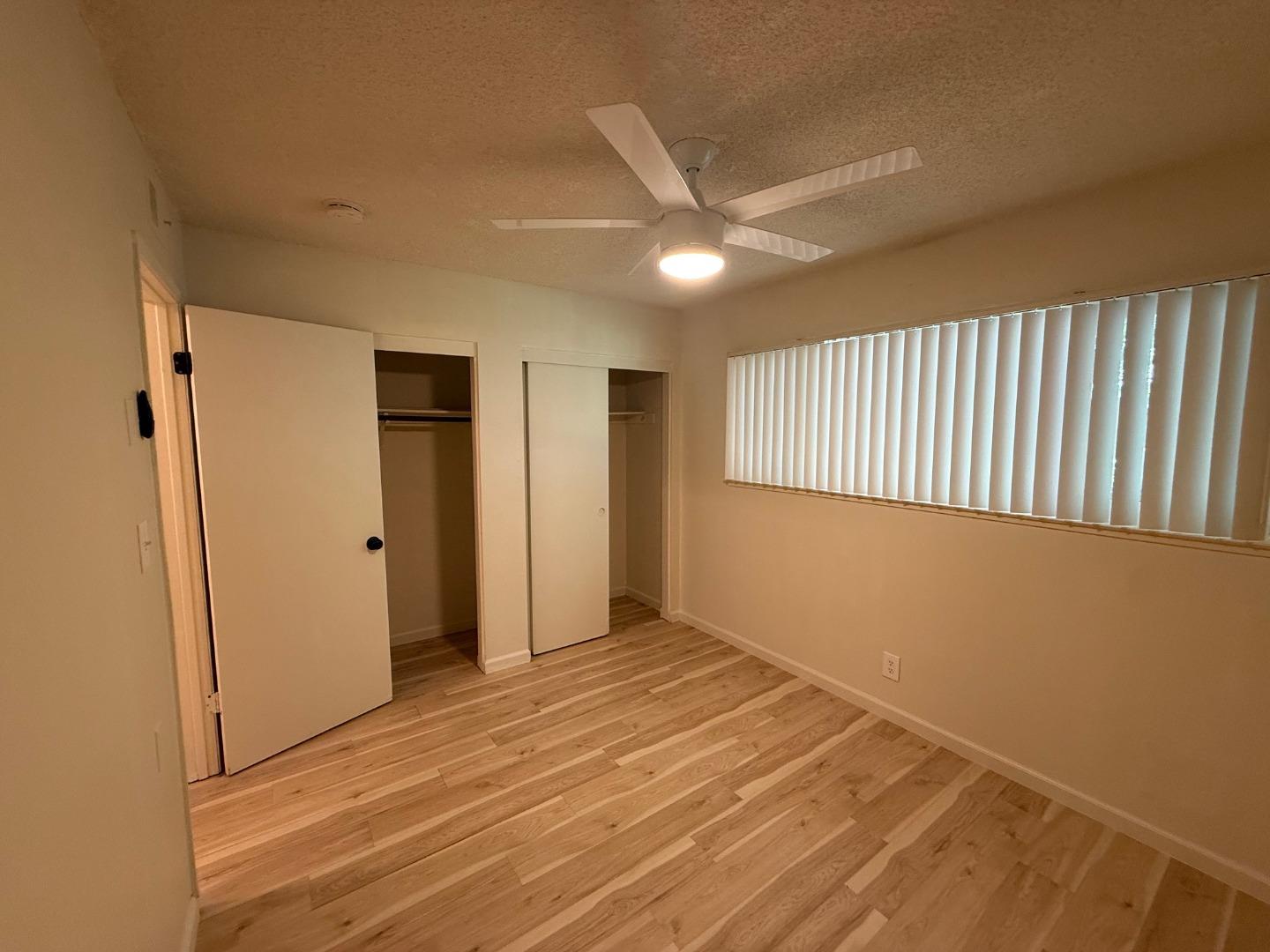2505 Prescott Road, Unit 1 Modesto, CA 95350 - Photo 33 of 42 a view of an empty room with wooden floor and a window