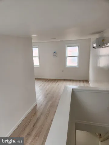 a view of wooden floor and windows in a room