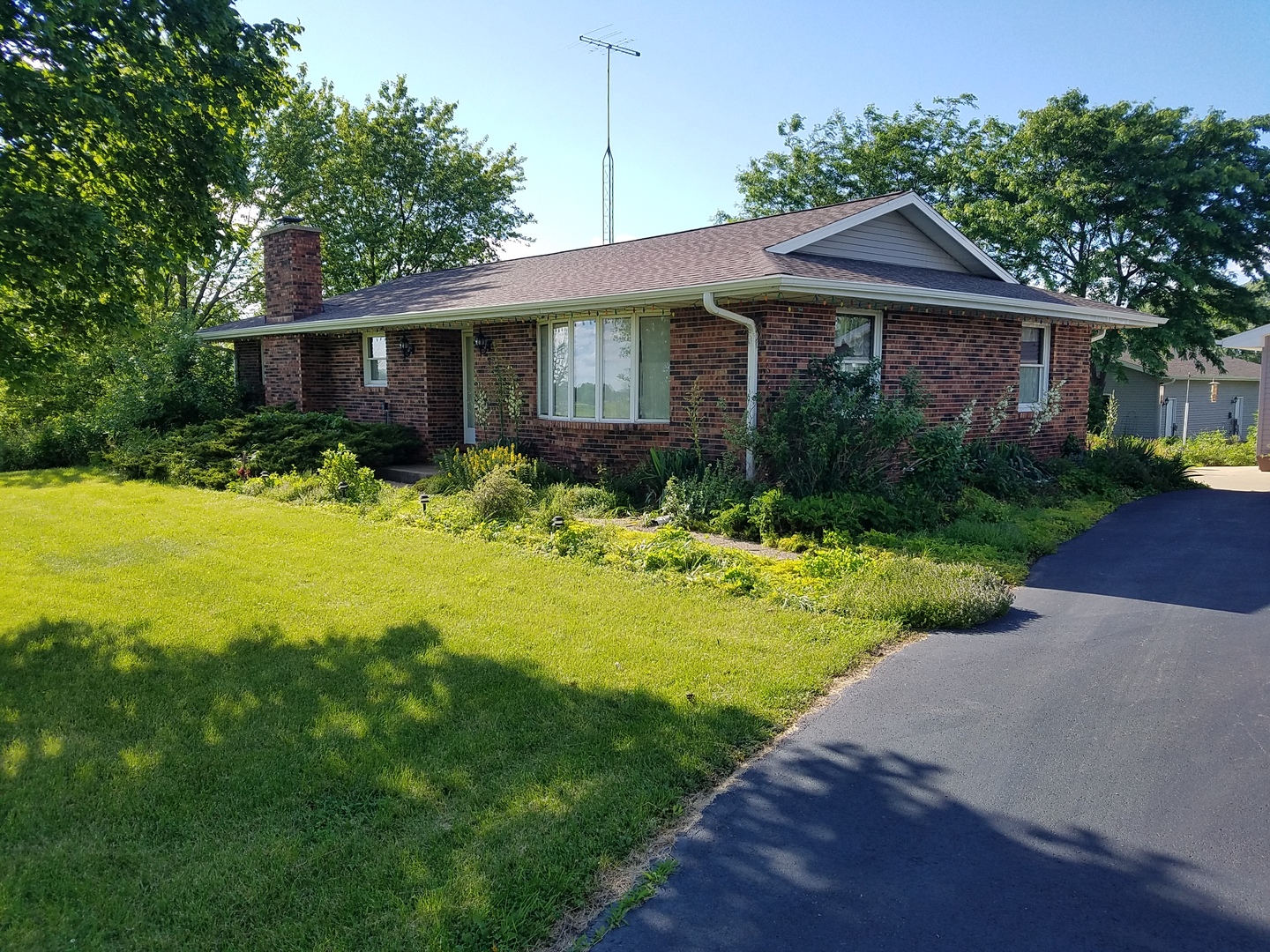 10730 East Fowler Road Rochelle, IL 61068 - Photo 1 of 37 a front view of a house with yard and green space