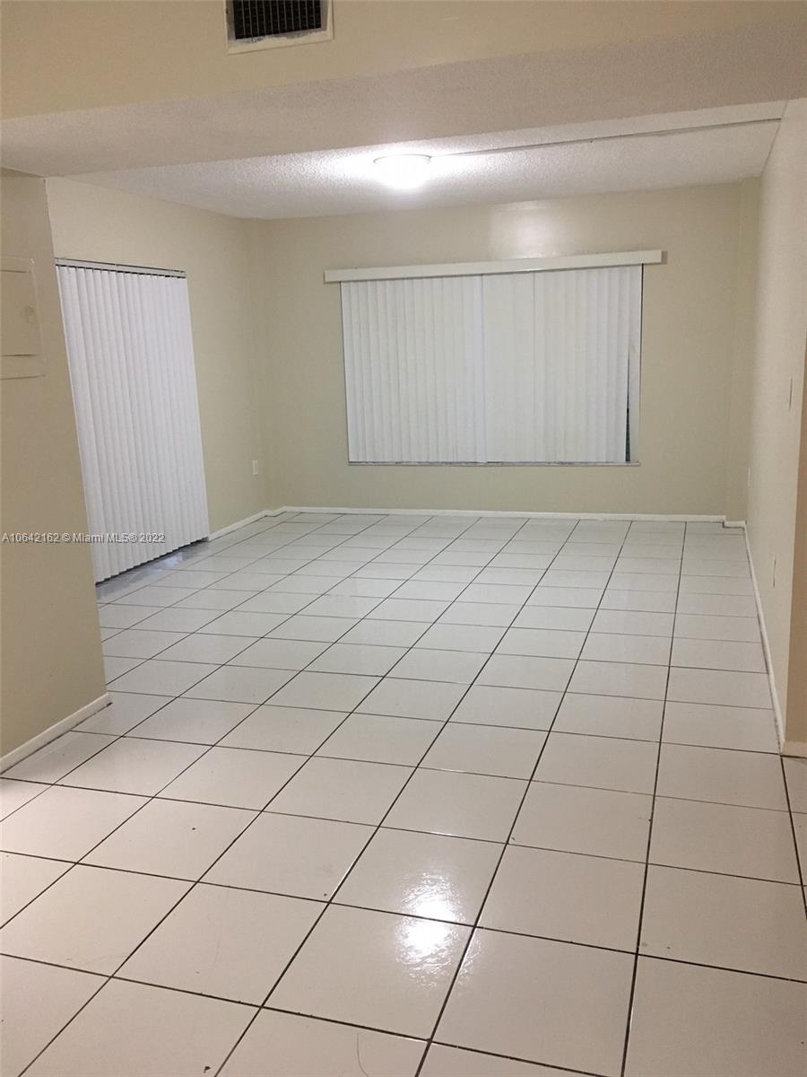4170 Inverrary Drive, Unit 111 Lauderhill, FL 33319 - Photo 14 of 28 a view of a livingroom with an empty space and a window
