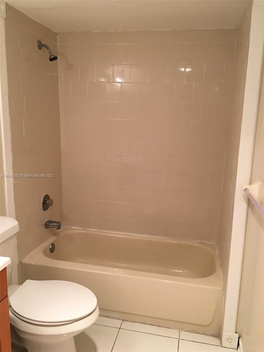 4170 Inverrary Drive, Unit 111 Lauderhill, FL 33319 - Photo 15 of 28 a bathroom with a bathtub and a toilet