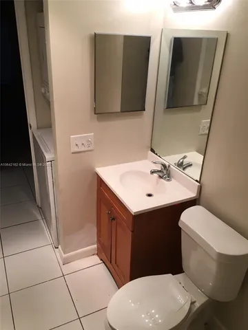 a bathroom with a sink a mirror and a vanity