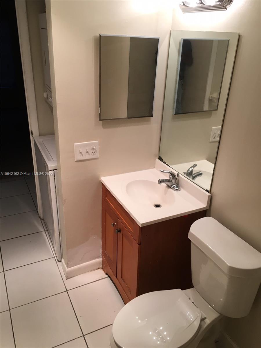 4170 Inverrary Drive, Unit 111 Lauderhill, FL 33319 - Photo 16 of 28 a bathroom with a sink mirror vanity and toilet